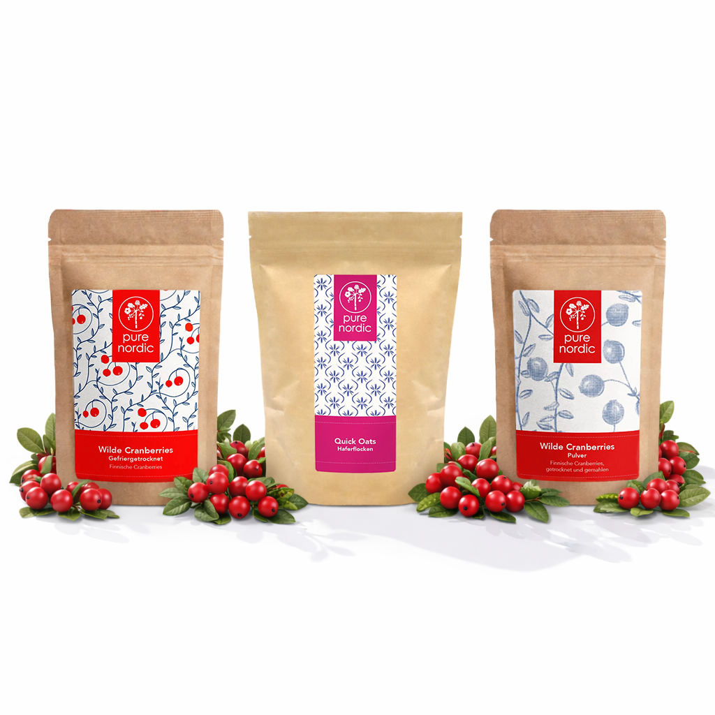 Dre Pure Nordic Beutel mit Cranberries und Haferflocken, umgeben von roten Beeren.